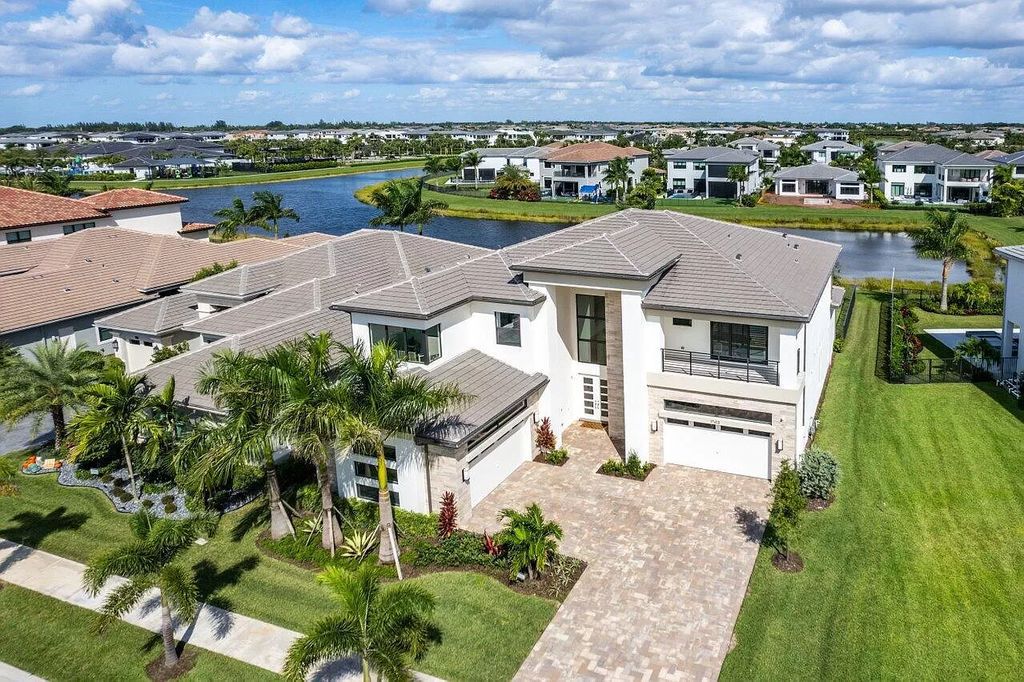 The Home in Boca Raton is a new transitional contemporary estate in the community of Boca Bridges with lake views now available for sale. This home located at 17413 Rosella Rd, Boca Raton, Florida