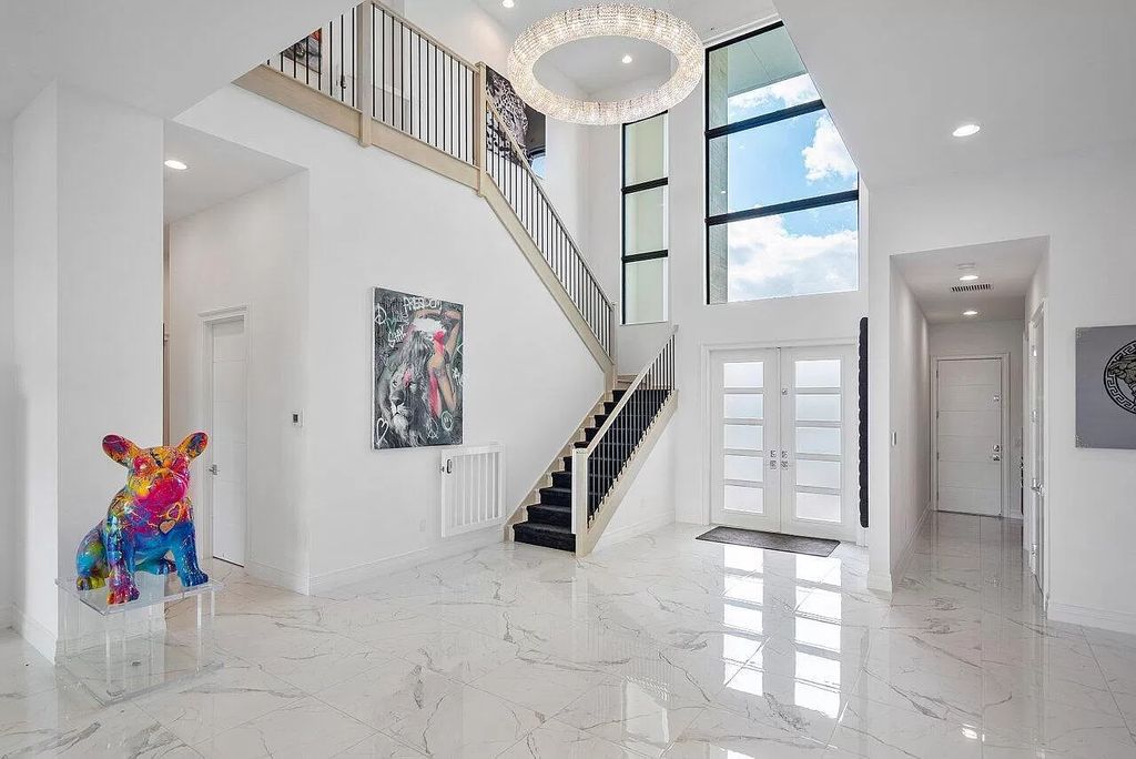 The Home in Boca Raton is a new transitional contemporary estate in the community of Boca Bridges with lake views now available for sale. This home located at 17413 Rosella Rd, Boca Raton, Florida