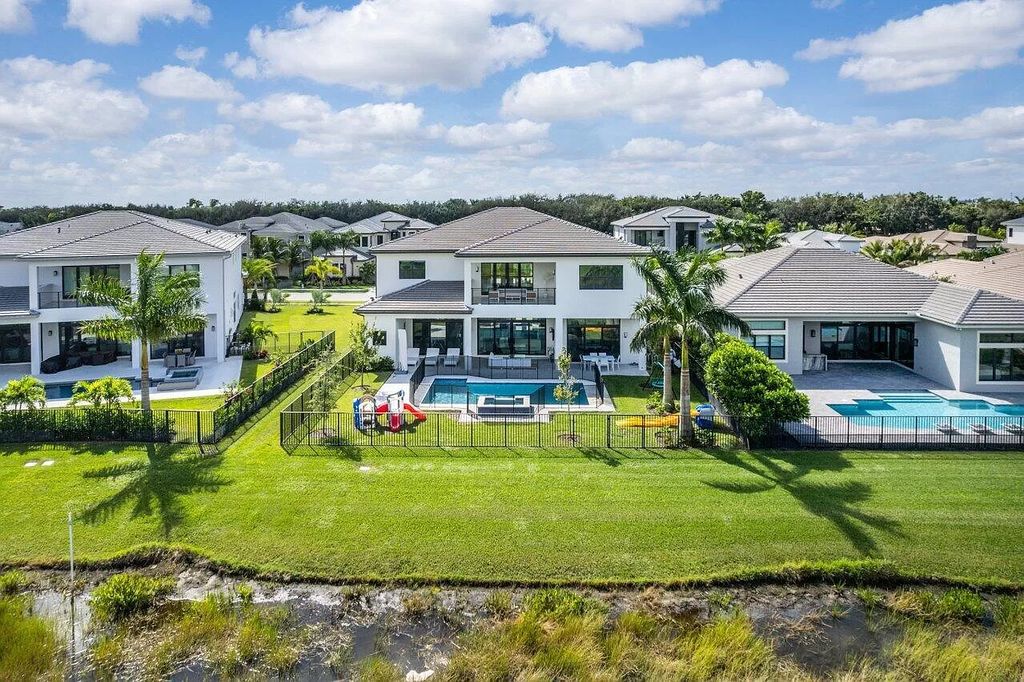 The Home in Boca Raton is a new transitional contemporary estate in the community of Boca Bridges with lake views now available for sale. This home located at 17413 Rosella Rd, Boca Raton, Florida