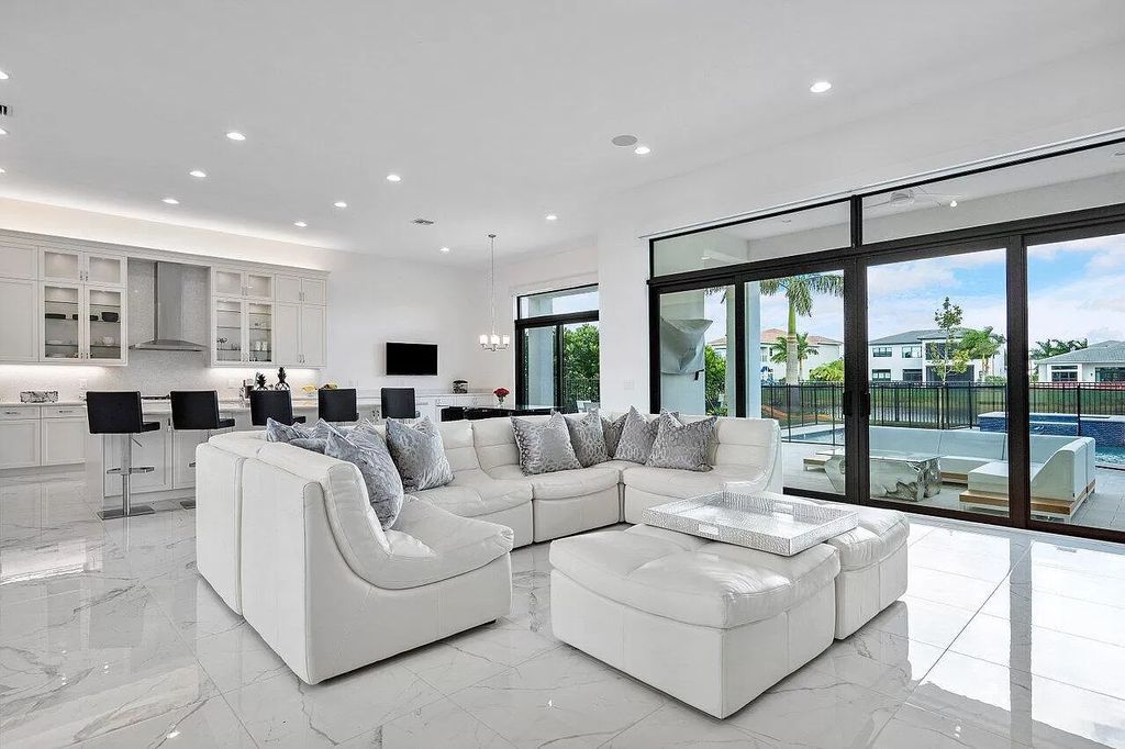 The Home in Boca Raton is a new transitional contemporary estate in the community of Boca Bridges with lake views now available for sale. This home located at 17413 Rosella Rd, Boca Raton, Florida