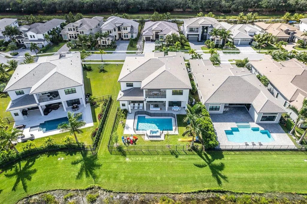 The Home in Boca Raton is a new transitional contemporary estate in the community of Boca Bridges with lake views now available for sale. This home located at 17413 Rosella Rd, Boca Raton, Florida