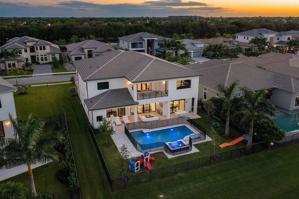 The Home in Boca Raton is a new transitional contemporary estate in the community of Boca Bridges with lake views now available for sale. This home located at 17413 Rosella Rd, Boca Raton, Florida