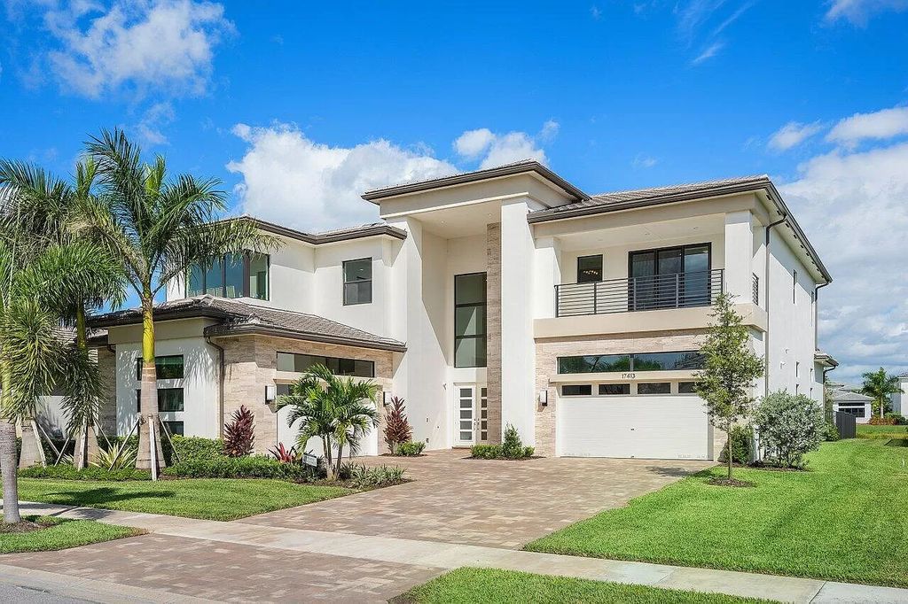 The Home in Boca Raton is a new transitional contemporary estate in the community of Boca Bridges with lake views now available for sale. This home located at 17413 Rosella Rd, Boca Raton, Florida