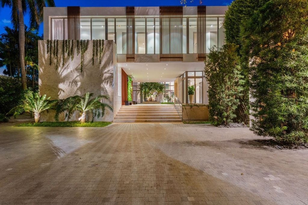 The Modern Waterfront Home in Miami Beach with unique architectural concept by Touzet Studio features lush landscaping now available for sale. This home located at 6396 N Bay Rd, Miami Beach, Florida