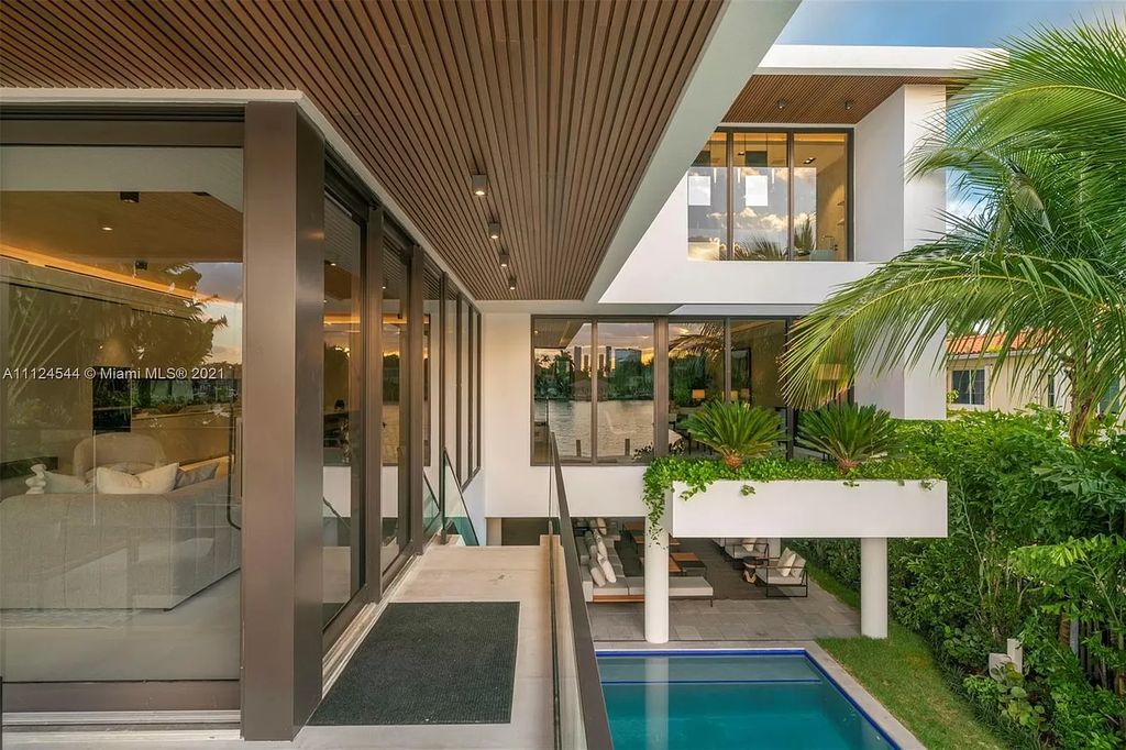 The Home in Miami Beach is a brand new tropical modern residence showcases a series of architectural moments, seamless indoor outdoor living now available for sale. This house located at 40 W Rivo Alto Dr, Miami Beach, Florida