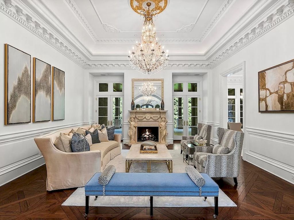 By using different textures, you can keep the look elegant. Living room with symmetrical layout that isn't dull because the scenery on both sides is absolutely different. From the sofa set to the picture steps on the wall, everything is in place. The homeowner chose polka dots for the grey couch to contrast with the rest of the monotone décor in the room.