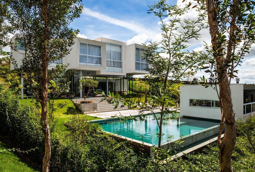 Neblina house, stunning white volumes on sloping plot by FGMF Arquitetos