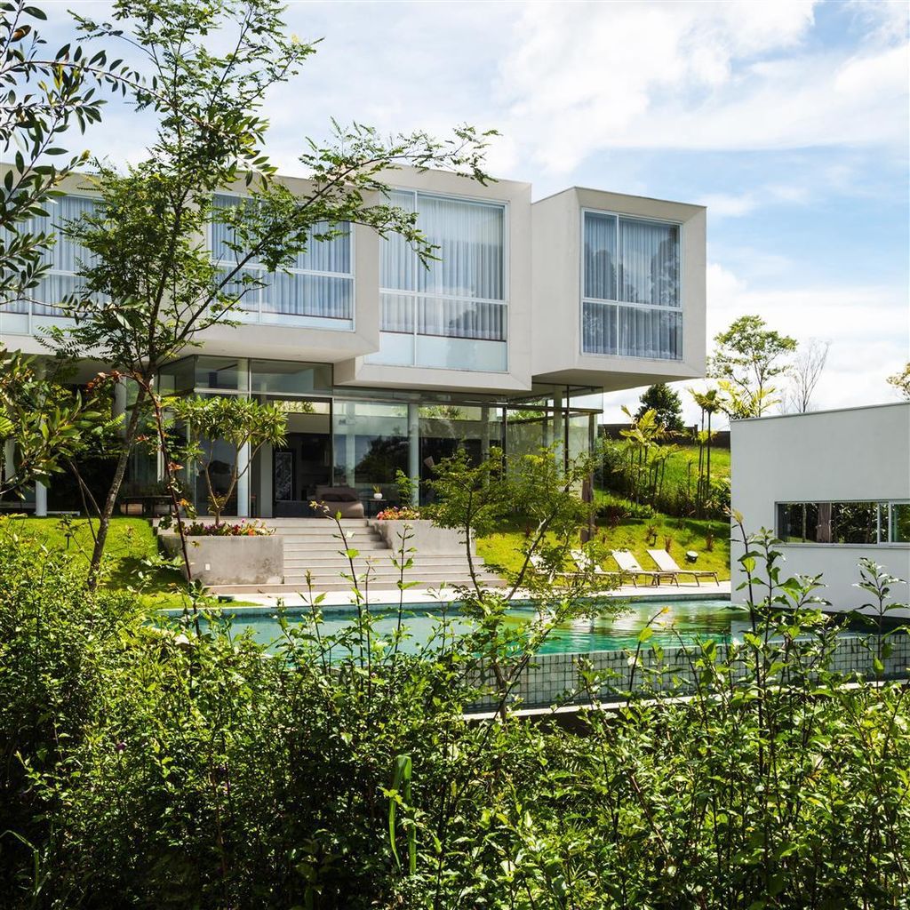 Neblina house, stunning white volumes on sloping plot by FGMF Arquitetos