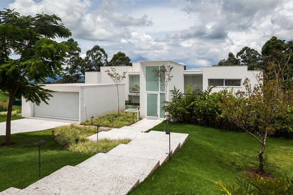 Neblina house, stunning white volumes on sloping plot by FGMF Arquitetos