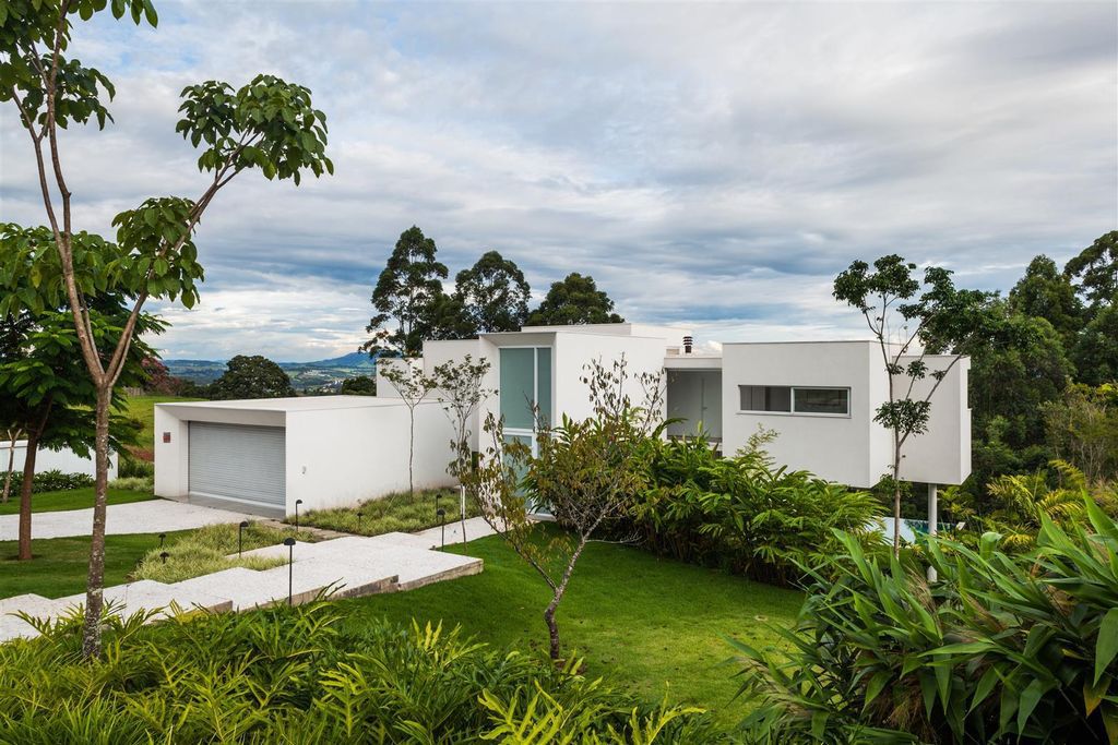 Neblina house, stunning white volumes on sloping plot by FGMF Arquitetos