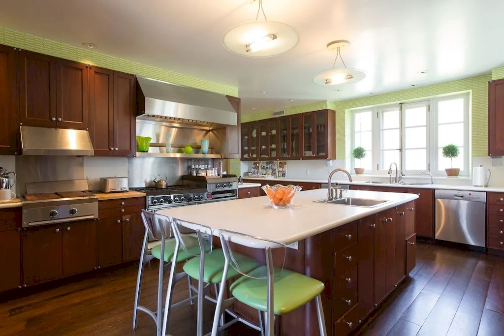 To enhance the overall aesthetic of your green kitchen, consider incorporating green chairs or stools in your kitchen island or dining area. These vibrant pops of green will not only add a playful element but also provide functional seating for your family and guests. Choose chairs or stools in shades of green that complement your kitchen's color scheme and style. Whether you prefer a subtle mint green or a bold lime green, these seating options will create a focal point and add a touch of personality to your kitchen.