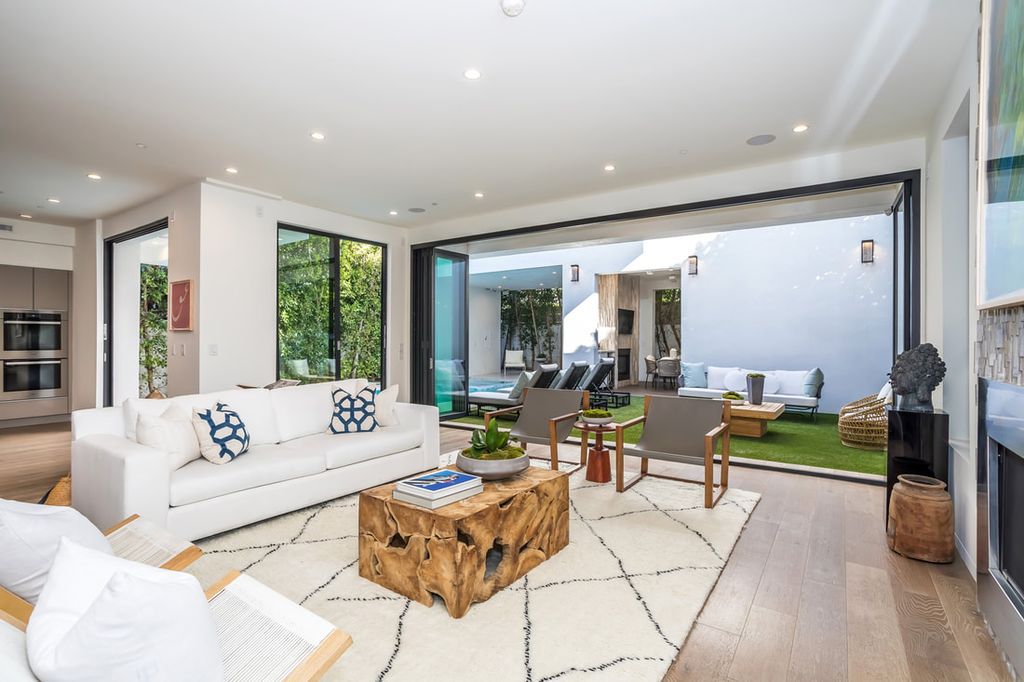 The Home in Los Angeles is a Stunning contemporary home gated for privacy on a prime street in the highly regarded Melrose Village now available for sale. This Estate located at 836 N Ogden Dr, Los Angeles