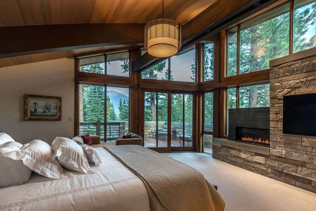 Who argues that contemporary designs are too simple? Rustic and dramatic, this bedroom is contemporary and minimalist. Without excessive ornamentation or color, a modest appearance is produced. The room is furnished with dark wood paneling on the walls and ceiling, wooden boards for the door frames, mood lighting, and a sizable, comfy bed.