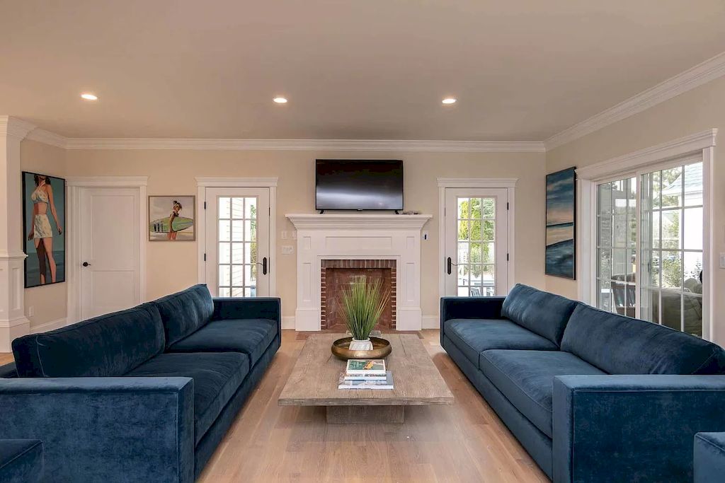 The chicness of this area is unmistakable, and the matte pink accents on the decorative elements add an attractive touch. An idea for a symmetrical living room with two velvet blue long couches on opposite sides. The designer chose a berry couch that is striking and becomes the focal point of the room in the backdrop space, which was painted pink.