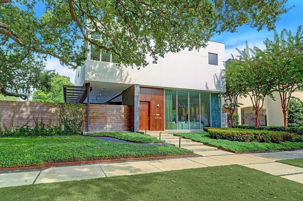 The Home in Houston is a modern architectural masterpiece with high-end finishes located on a corner lot in Royden Oaks now available for sale. This home located at 3842 Piping Rock Ln, Houston, Texas