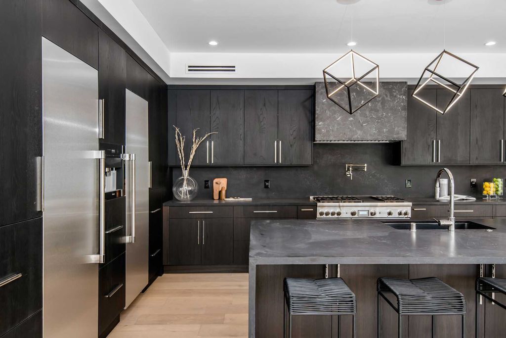 All-over black cabinets create a bold and dramatic statement in the kitchen space. The sleek and modern look of black cabinets adds a sense of sophistication and luxury to the overall design. This striking color choice lends a contemporary and edgy feel, making the kitchen a stylish and captivating area that stands out with its unique charm. With such a luxury idea, your family meals will become even more relaxing and enjoyable than ever before.