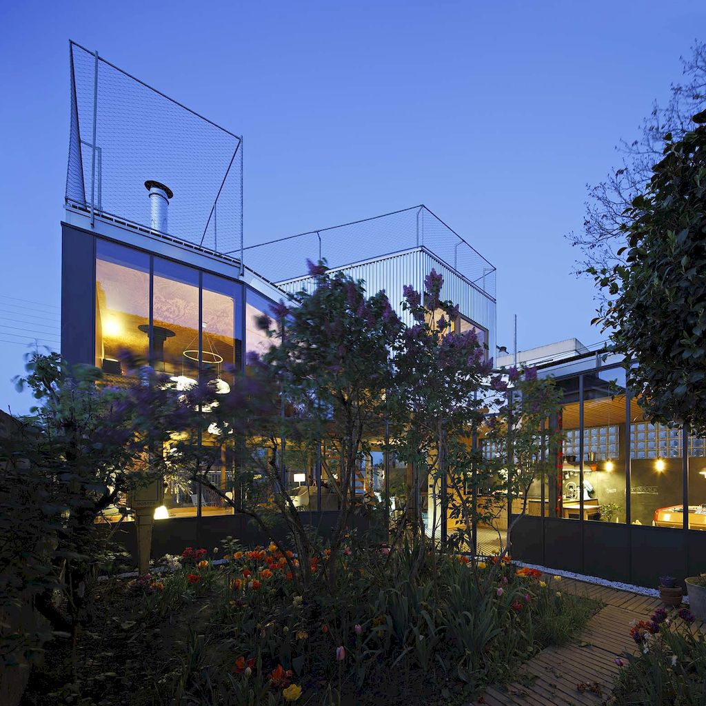 Landscape house features metal wall, sloping roof terrace by Mabire Reich