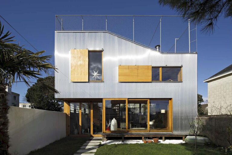 Landscape House features metal wall, sloping roof terrace by Mabire Reich