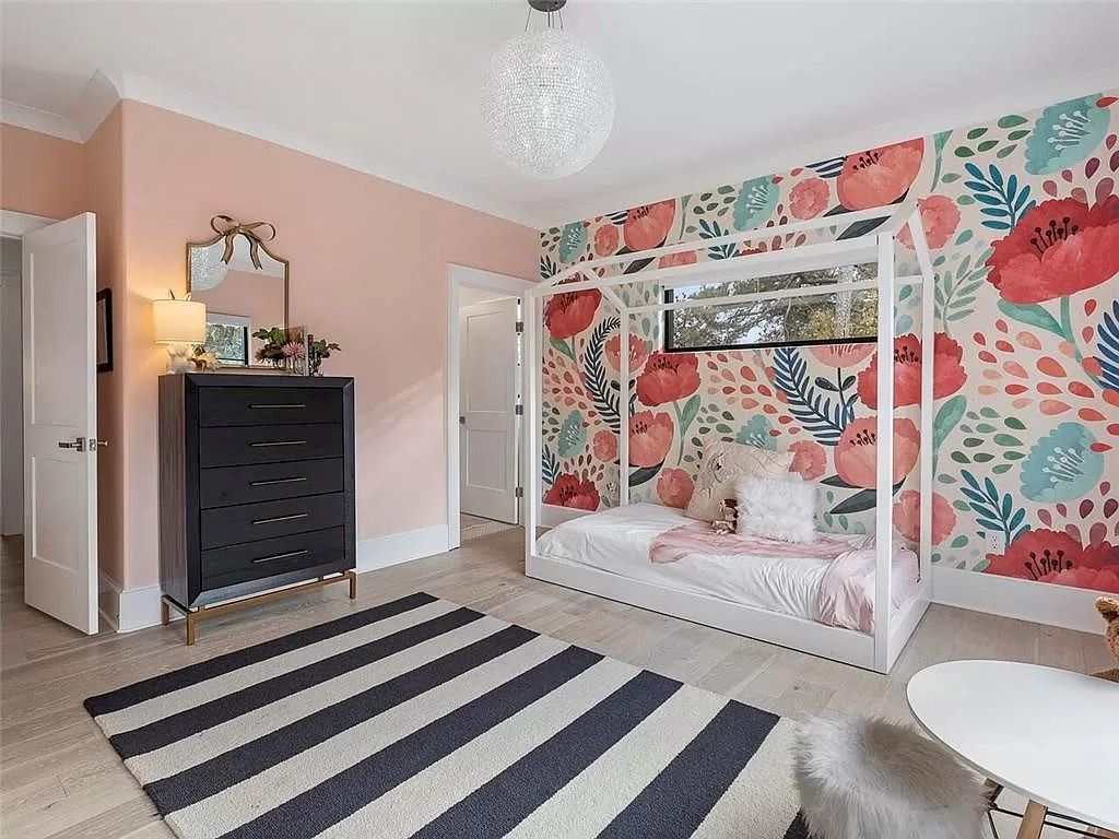 Pink can be introduced without using a big block of color. Splashes of the color look stunning against a light background, like this large wall painting, and offer a clever way to use it in your bedroom. Bed linen and an area rug can be used to tie the various tones together.