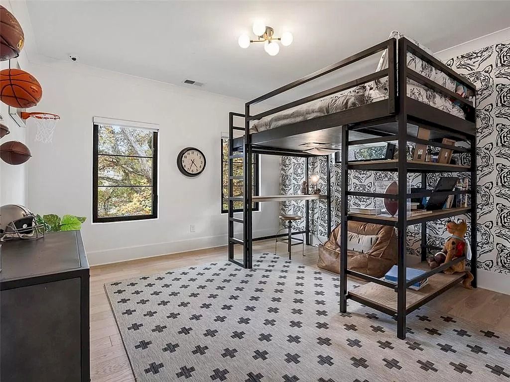 This adolescent room's loft bed, which provides space for a large desk underneath, as well as a quaint reading nook with a comfortable armchair, were both incorporated into the interior design.