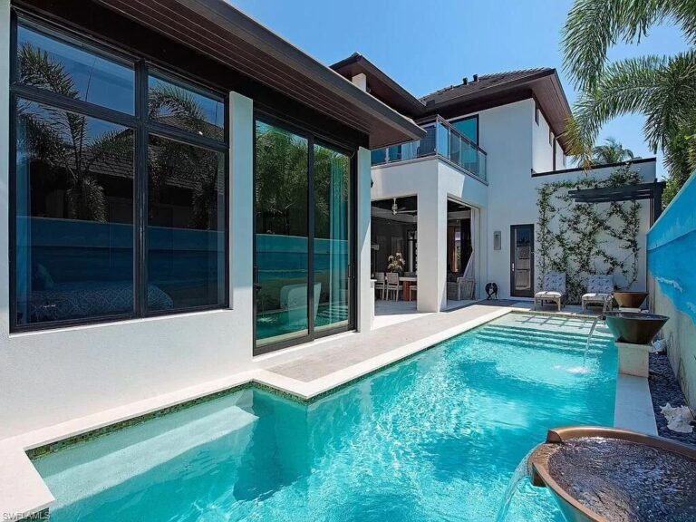 This $12,500,000 Tropical Home in Naples offers High end Finishes Throughout and Expansive Open Floor Plan