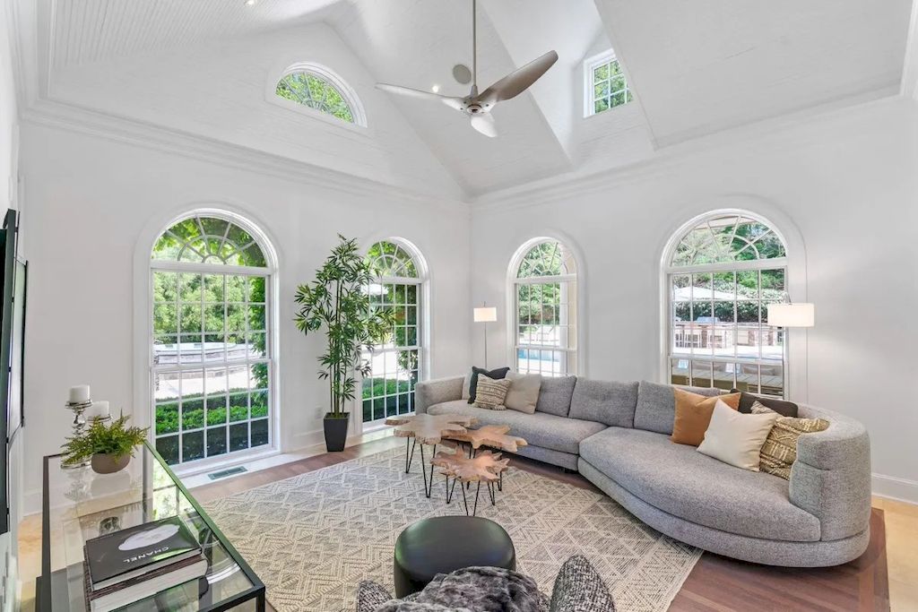 The grey couch looks fantastic next to the tree, which helps to soften the industrial feel. On the table, you can place a tall tree in a gorgeous pot or a flower vase. Furthermore, the center table has a wooden top, which helps to bring this living room closer to nature