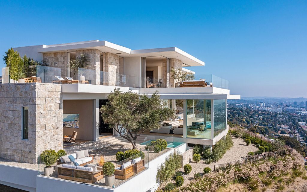 The Bel Air Mansion is a transitional organic modern jewel hovers above the City of Angels with explosive jetliner views now available for sale. This home located at 8201 Bellgave Pl, Los Angeles, California