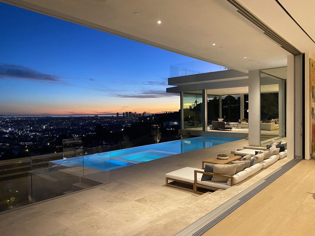 The Bel Air Mansion is a transitional organic modern jewel hovers above the City of Angels with explosive jetliner views now available for sale. This home located at 8201 Bellgave Pl, Los Angeles, California