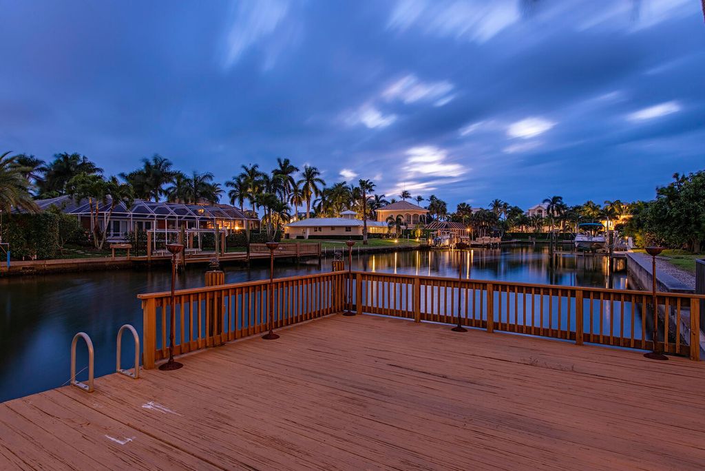 The Home in Naples is a privately situated custom Gulf access estate has a circular paver driveway and mature lush landscaping now available for sale. This home located at 160 Seabreeze Ave, Naples, Florida