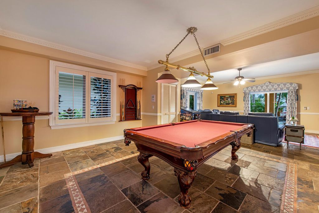 The Home in Naples is a privately situated custom Gulf access estate has a circular paver driveway and mature lush landscaping now available for sale. This home located at 160 Seabreeze Ave, Naples, Florida