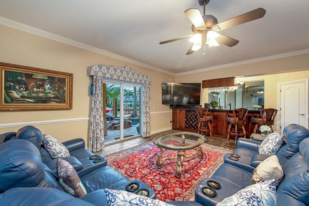 The Home in Naples is a privately situated custom Gulf access estate has a circular paver driveway and mature lush landscaping now available for sale. This home located at 160 Seabreeze Ave, Naples, Florida