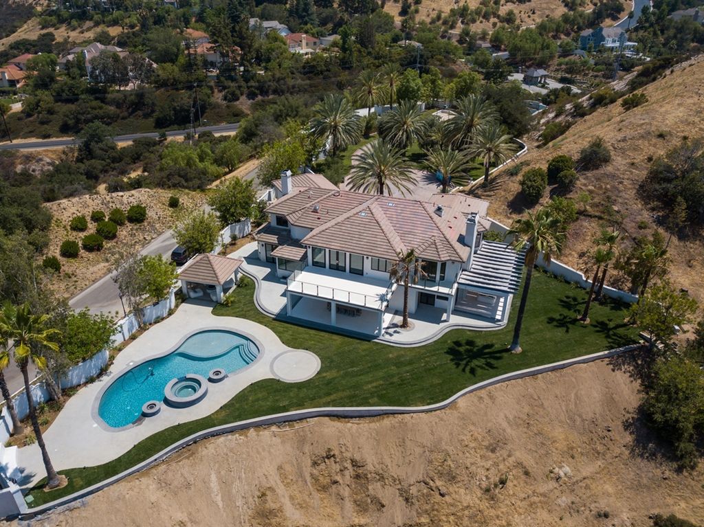 The Calabasas Home is a Stunning, custom built, tennis court estate nestled behind two gates offering superb privacy now available for sale. This home located at 24119 Saint Andrews Ln, Calabasas, California