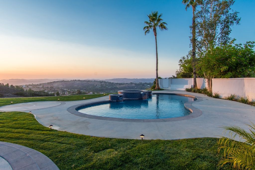 The Calabasas Home is a Stunning, custom built, tennis court estate nestled behind two gates offering superb privacy now available for sale. This home located at 24119 Saint Andrews Ln, Calabasas, California