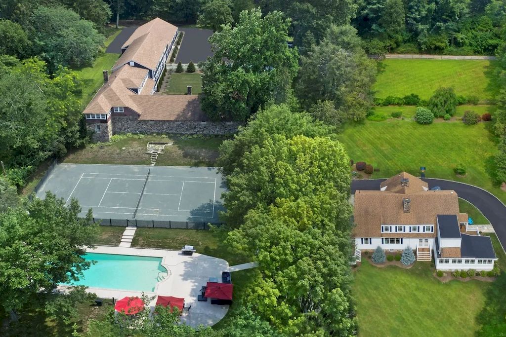 The Home in Connecticut is a luxurious home updated with an outdoor pool, a tennis court, a greenhouse and other amenities now available for sale. This home located at 849 Lake Ave, Greenwich, Connecticut; offering 05 bedrooms and 06 bathrooms with 5,221 square feet of living spaces.