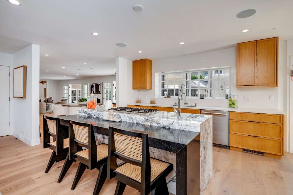 The Home in Beverly Hills is a Completely renovated masterpiece with the sprawling backyard featuring a brand new swimmer's pool now available for sale. This home located at 607 N Elm Dr, Beverly Hills, California