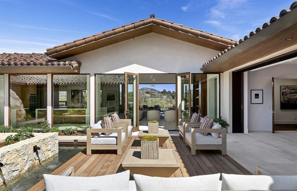 The Home in Rancho Santa Fe is an exquisite luxury oasis conceived by top team builder & design visionaries offering incomparable unobstructed views now available for sale. This house located at 18080 Via De Fortuna, Rancho Santa Fe, California
