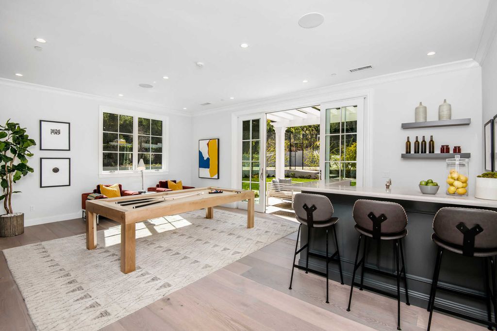 The Home in Encino is an exquisite new construction estate with a spacious great room, a home theater with 12 automatic chairs and more now available for sale. This home located at 4509 Noeline Ave, Encino, California