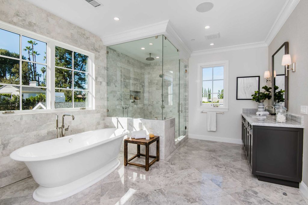 The Home in Encino is an exquisite new construction estate with a spacious great room, a home theater with 12 automatic chairs and more now available for sale. This home located at 4509 Noeline Ave, Encino, California