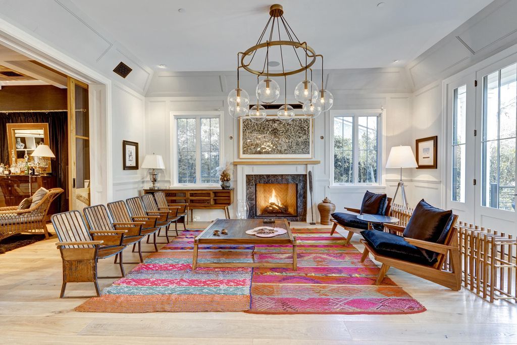 Symmetry is often applied to traditional living rooms. A central fireplace with two alcoves that you see a lot in traditional homes. Adding a focal point in the heart of a fireplace, whether it's a mirror, wall sculpture, or window gives any room a classic, timeless elegance that doesn't have to be searched for. The owner of this living room expects to take absolute symmetry to the next level in the arrangement of versatile chairs. 