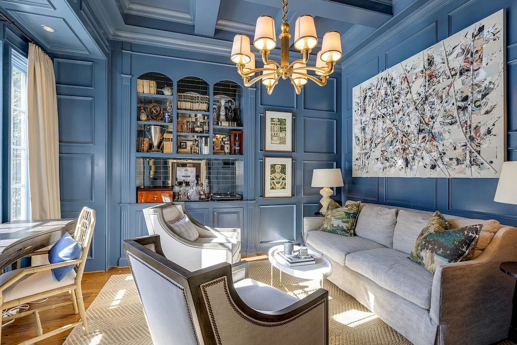 Set the tone for your living room by painting the entire space navy blue. Although blue is a cold color, when used in a moderate space with a bold color tone, it creates coziness and cohesion in the living room. A chandelier and a soft sofa set are enough to make the room feel relaxing.