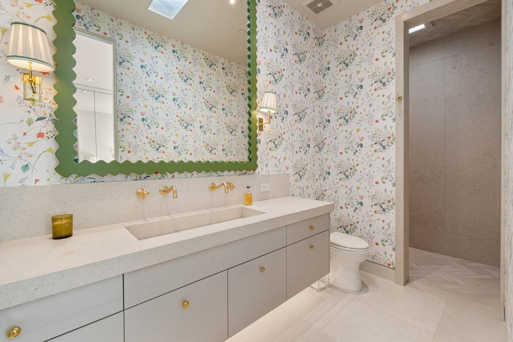 If you're looking for gray bathroom ideas, consider hanging patterned wallpaper to add some visual interest and texture to the space. Patterned wallpaper can make a bold statement or add a subtle touch of elegance depending on the design. To create a cohesive look, choose a wallpaper with shades of gray that complement the existing color scheme of the bathroom. 