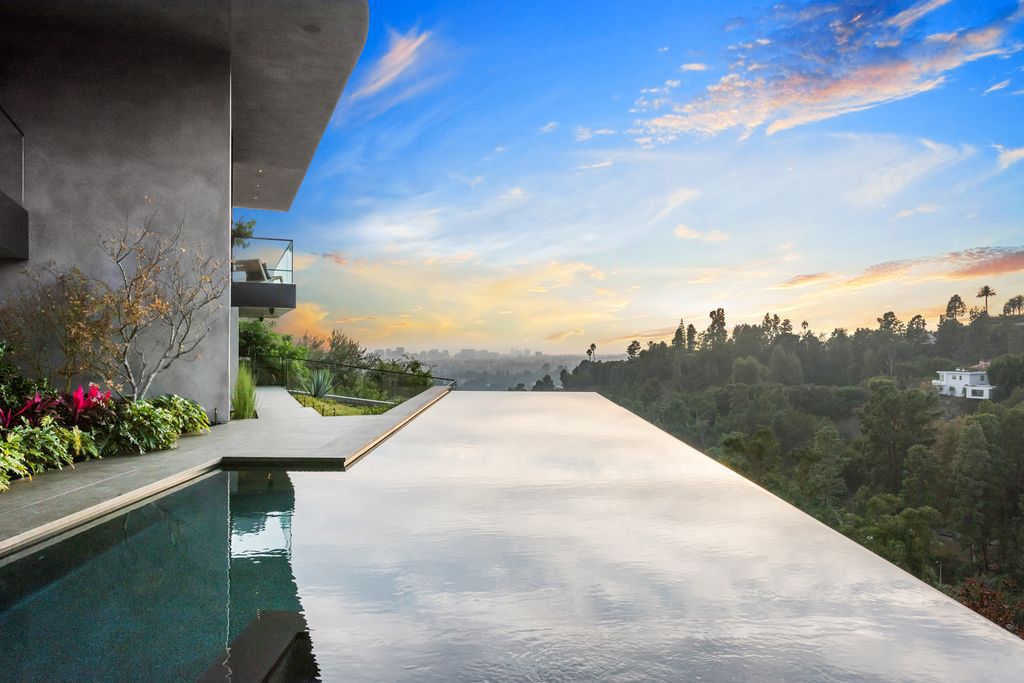 The Mansion in Beverly Hills is an architectural triumph is perched high up on the hillside using the finest materials and featuring breathtaking views now available for sale. This home located at 9420 Readcrest Dr, Beverly Hills, California
