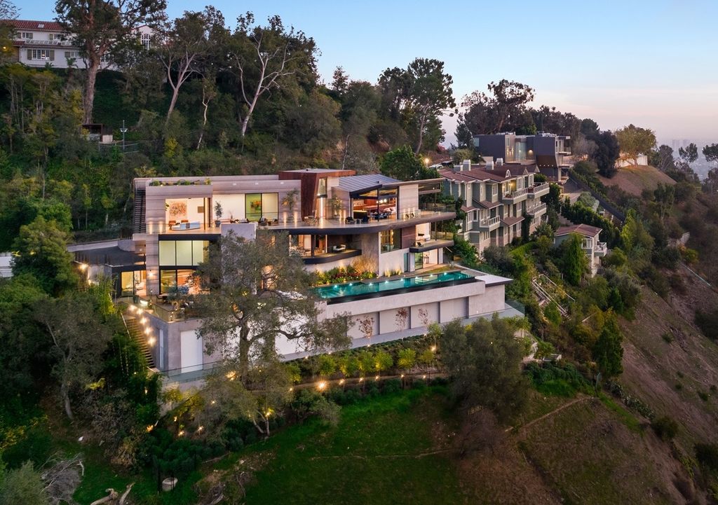 The Mansion in Beverly Hills is an architectural triumph is perched high up on the hillside using the finest materials and featuring breathtaking views now available for sale. This home located at 9420 Readcrest Dr, Beverly Hills, California