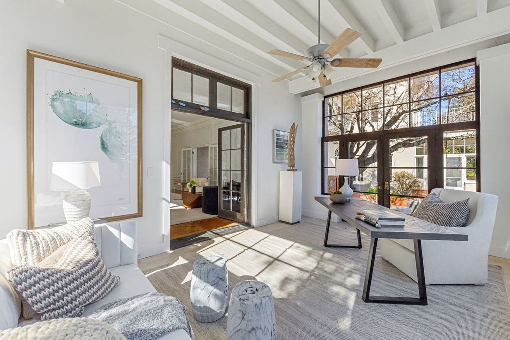 This living room's furnishings was methodically chosen to include the ideal sofa and chairs. The end result is a room that tests balance and restraint. The art and photography collection gives this house a few more unique touches.