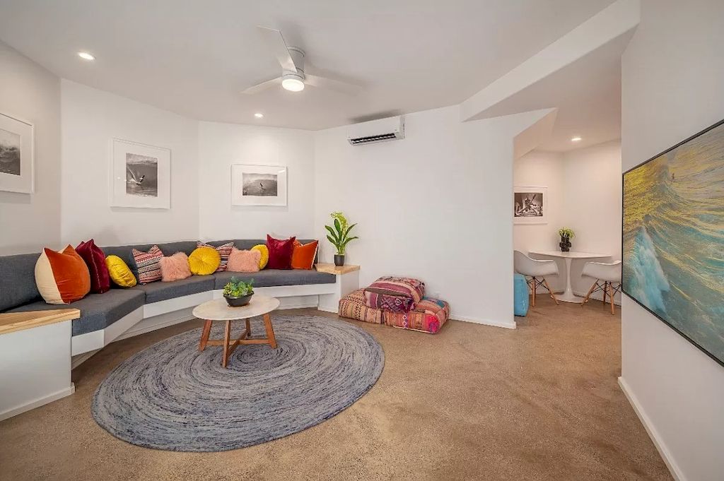 Use textures to replicate your love of pink on any object in your living room. A solid white pedestal supports this gray couch living room, which is accented with some colorful pillows. This tip is great because it's simple to change up the furniture and decor for a more versatile look.