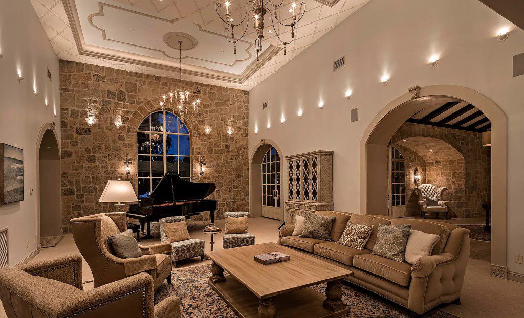 Besides the stone fireplace is always considered an iconic element of Traditional Living Room Ideas, you can completely opt the natural stones for other details. As you may see, the stone wall in this above idea is not only the background to display musical instruments, but also the focal point of this space. The lighting system is also installed very delicately and attractive in this living room idea to enhance your favorite area. This is truly a miniature stage serving for family and friends gatherings.