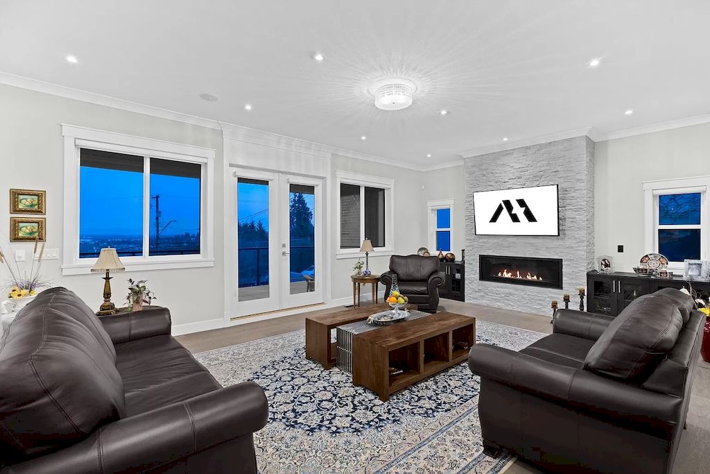 This all-white space might look cold and uninviting without the comfy dark brown sofa to warm things up. A mix of blue tone with interesting textures and furnishings inject small pops of color into the room. The all-white wall crisply contrasts the sofa's dark brown color and rounded edges