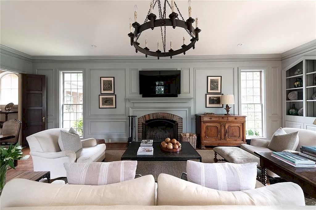 Earthy colors are always a terrific choice for warm, rustic living room designs. With its low ceiling and green-gray paint, which is a new hue for 2022, this living room creates a cozy and welcoming ambiance. This color looks great with white and calming grays in a typical country house setting. Add a sleek, contemporary accent.