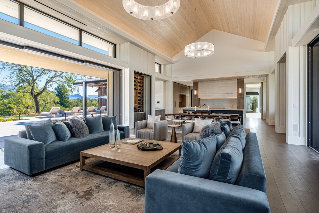 Teal work well on a variety of fabrics such as the living room sofa set in blue teal velvet or the rug in gray tones combining with patchy textures in this living room example. Thanks to that, the living room becomes much more modern and eye catching. 