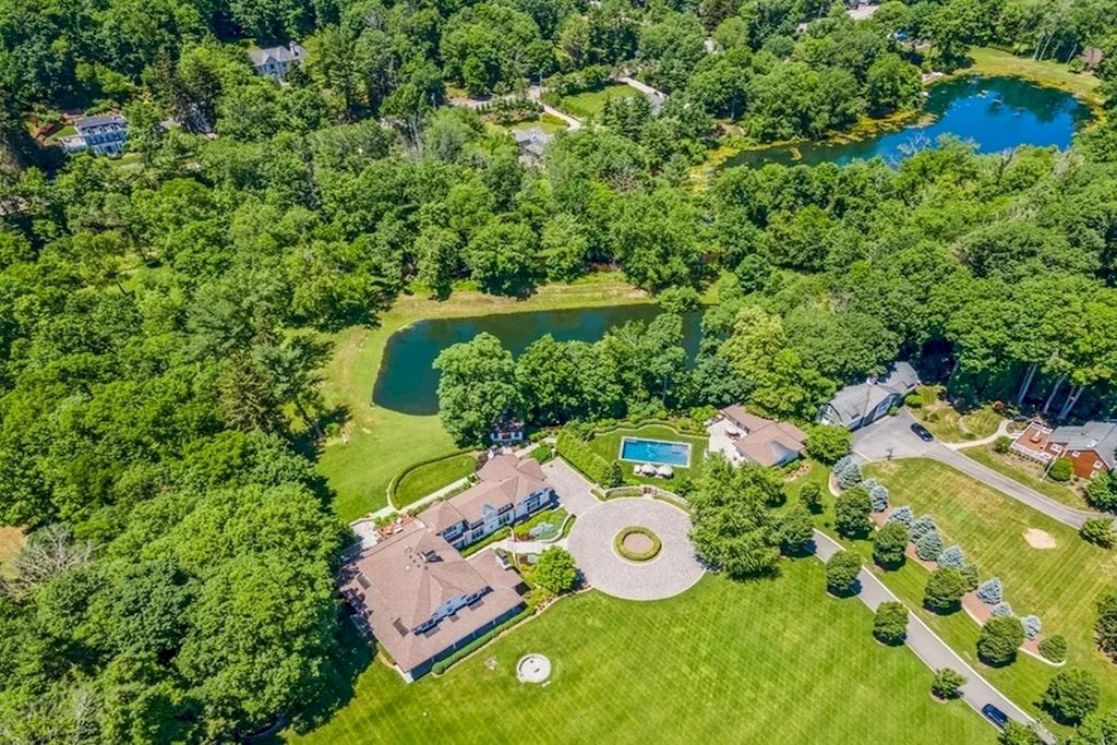 The Home in New Jersey is a luxurious farmhouse compounds featuring soaring ceilings, glass walls, a beautiful pool, a gallery and more now available for sale. This home located at 255 E Saddle River Rd, Saddle River, New Jersey; offering 06 bedrooms and 07 bathrooms with approximately 10 acres of land.